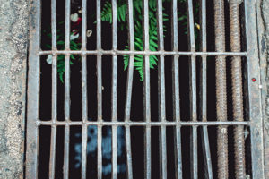 close up of rusty iron grate on the road.